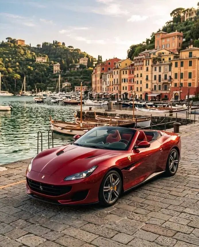 Product campaign image for a dealer or showroom: red convertible in Portofino harbour